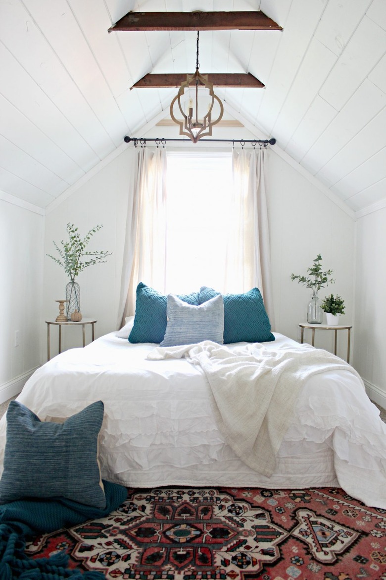 white bedroom with wooden beams and pendant attic bedroom lighting ideas