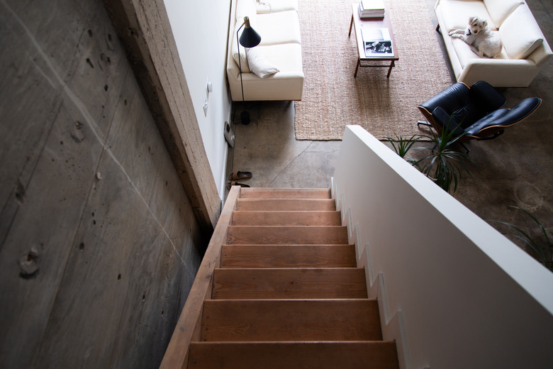 attic idea with wooden stairs and white railing