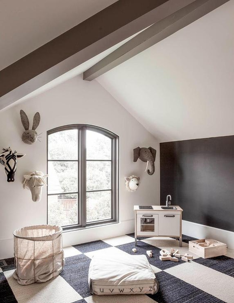 Attic playroom with felt animal heads decor and mini kitchen