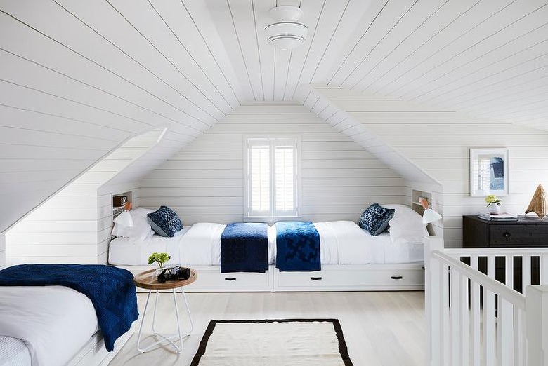 attic storage with white shiplap in kids' bedroom