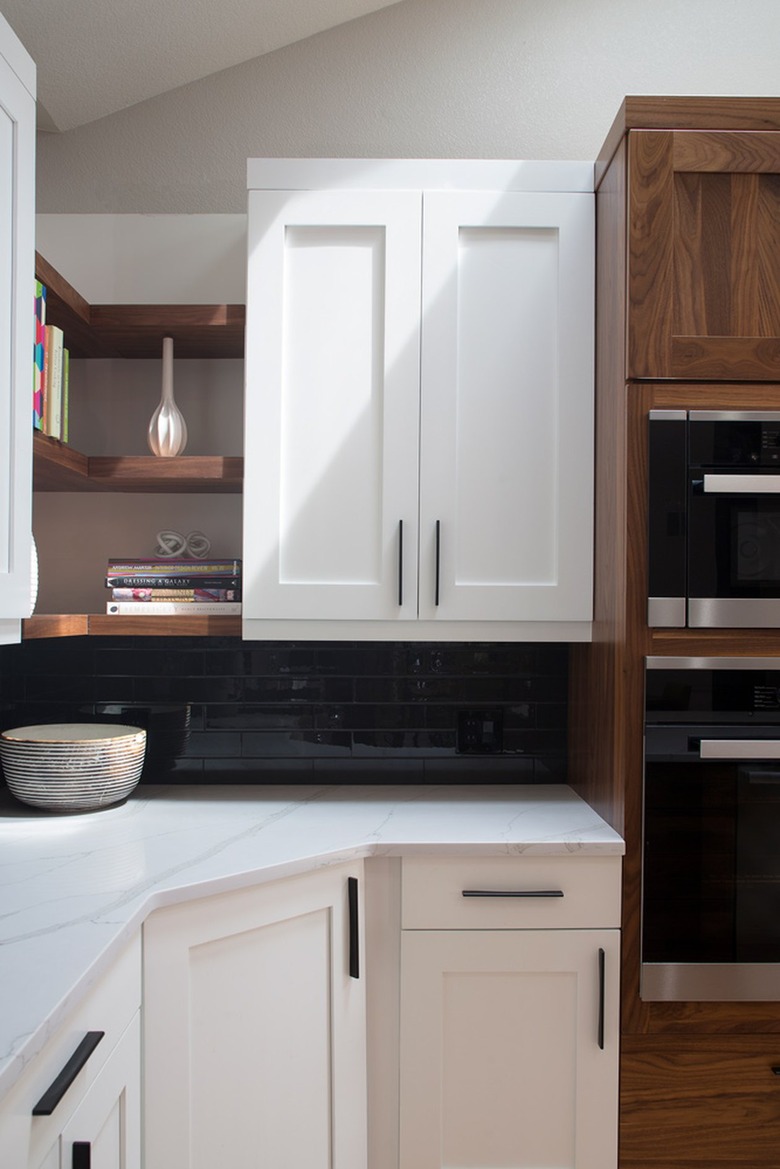 Black backsplash with white kitchen cabinets