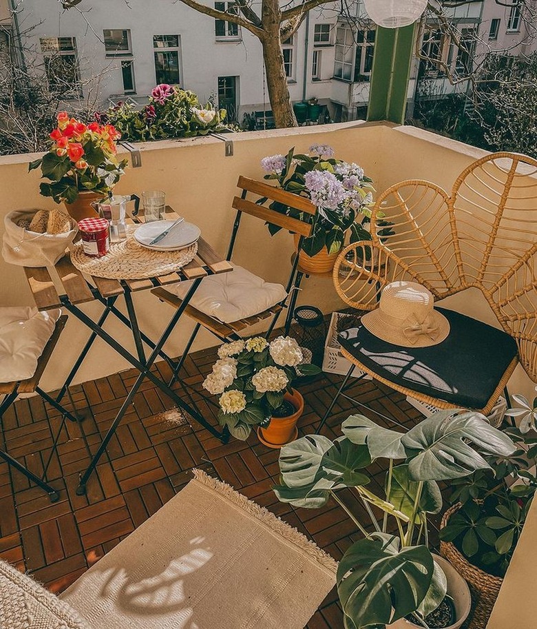 bistro set on balcony with flowers