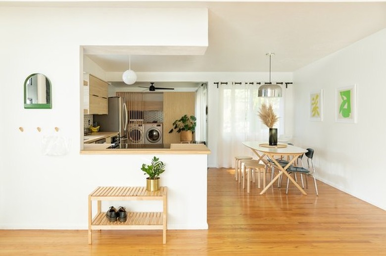 Kitchen with small island, dining set, wood floors.