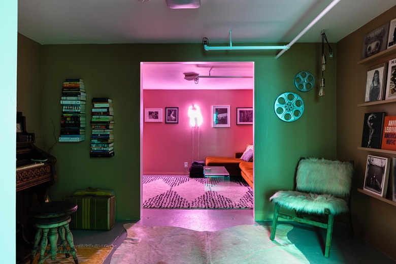 basement family room ideas with bearskin rug, neon light, and fur covered chair