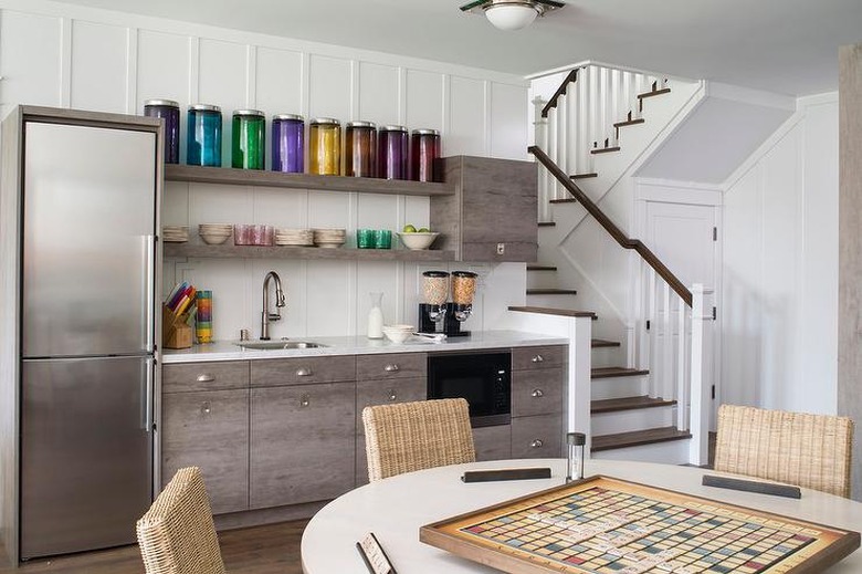 basement kitchen with steel appliances and white tulip table