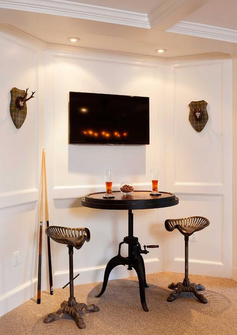 basement man cave ideas with bar stools and mounted antlers