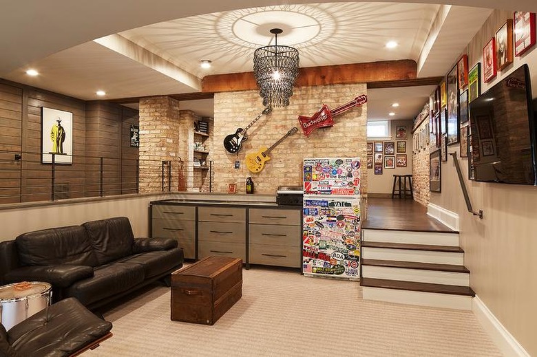 basement man cave ideas with chandelier and mounted guitars