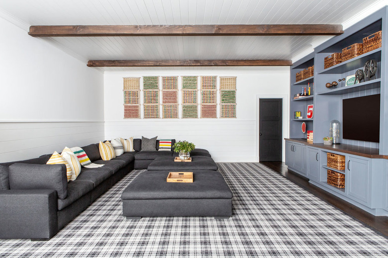 white basement paint colors with exposed wood beams and blue built in media center