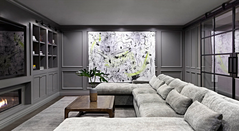 basement wall ideas with abstract art piece in gray basement with a sectional couch