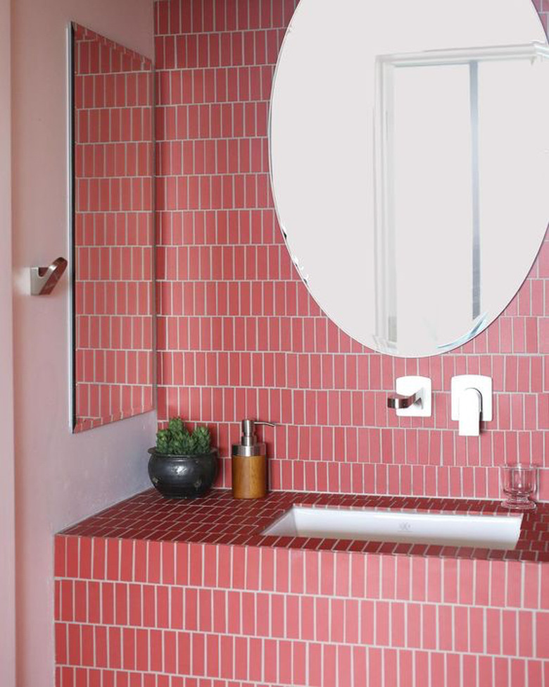 pink ceramic tile on bathroom wall and vanity