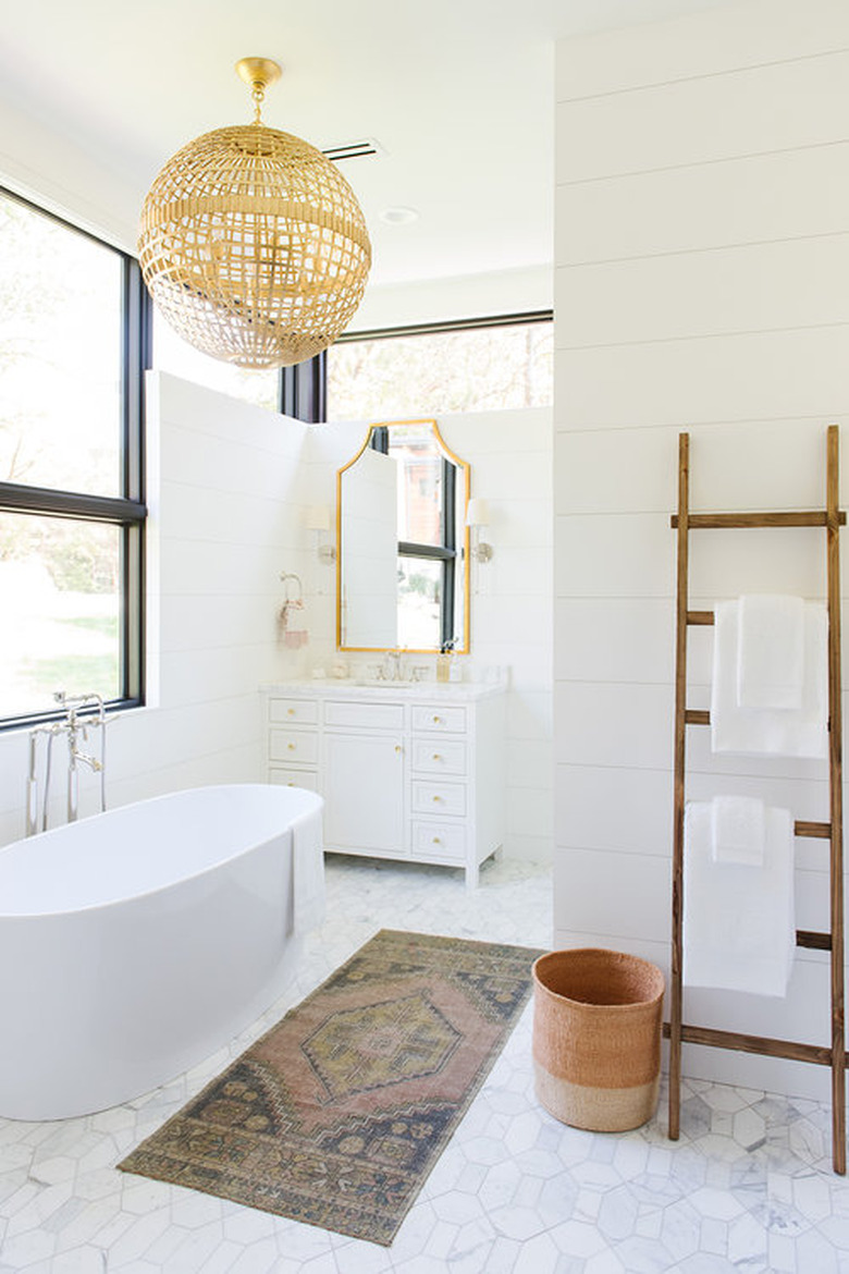 bathroom organization idea with freestanding tub and towel rack