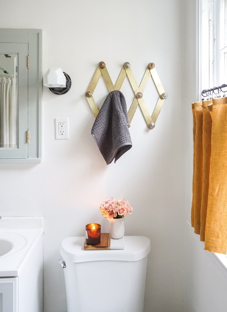 bathroom organization idea with accordion towel rack