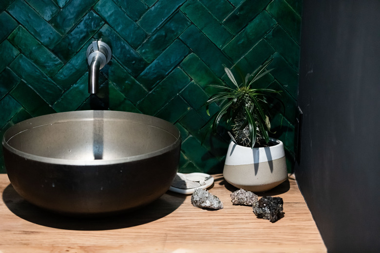 bowl bathroom sink with dark green chevron wall tile