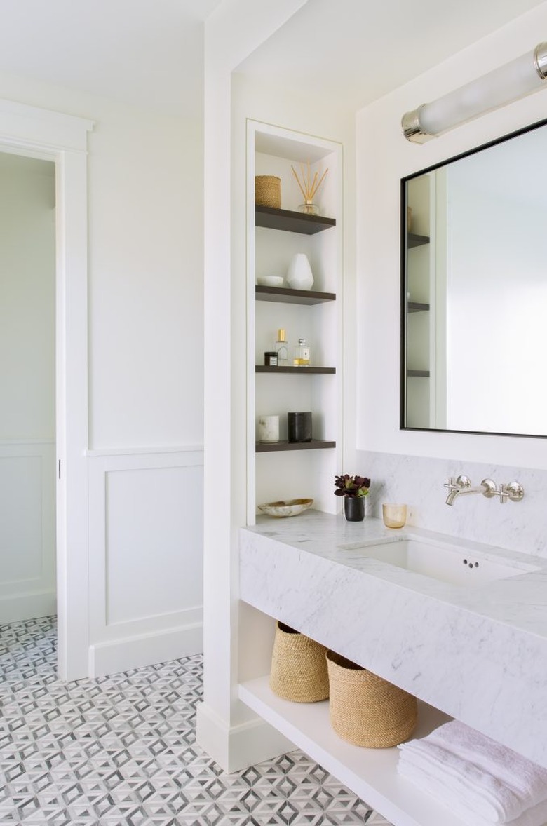 bathroom storage idea with built-in niches and towel storage under sink