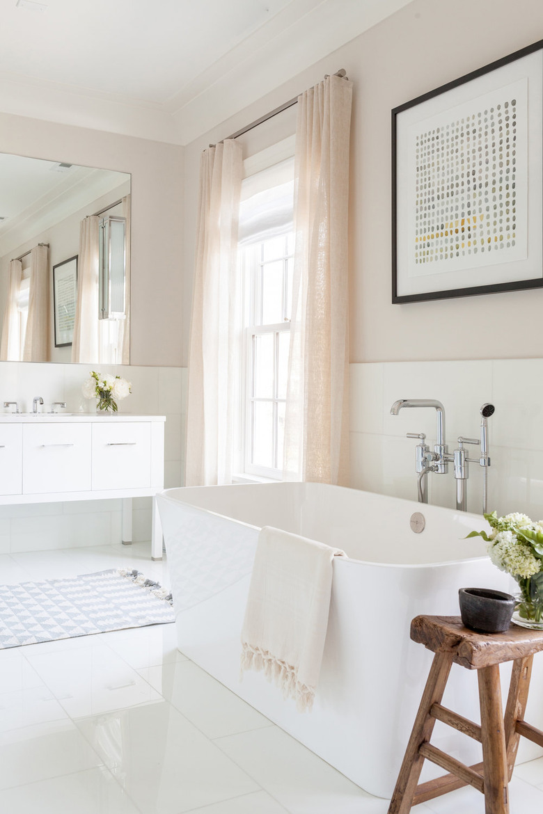 bathroom tub backsplash idea with large rectangular tile behind freestanding tub