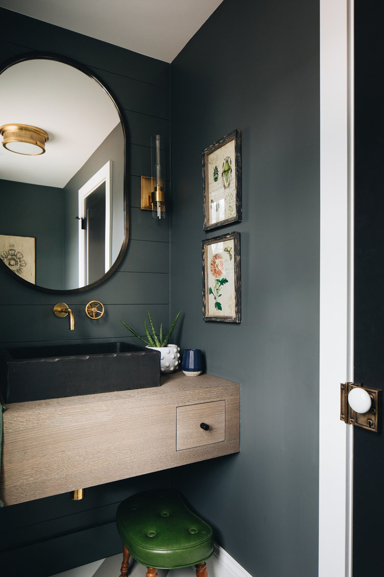 Bathroom under stairs with dark gray shiplap and black vessel sink