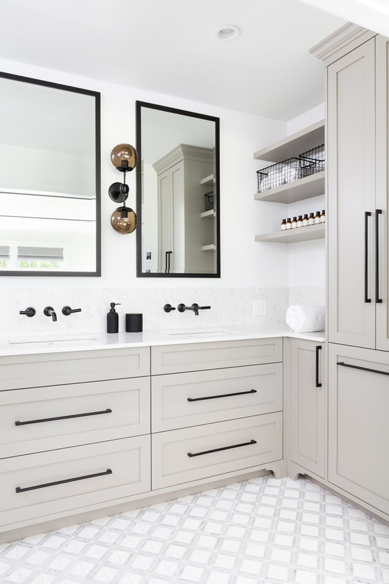 silver gray vanity cabinet with white walls and black accents