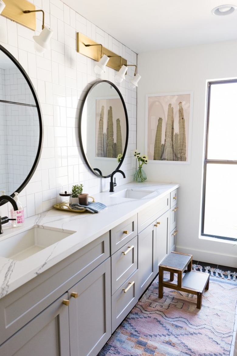 gray double vanity cabinet with brass door hardware