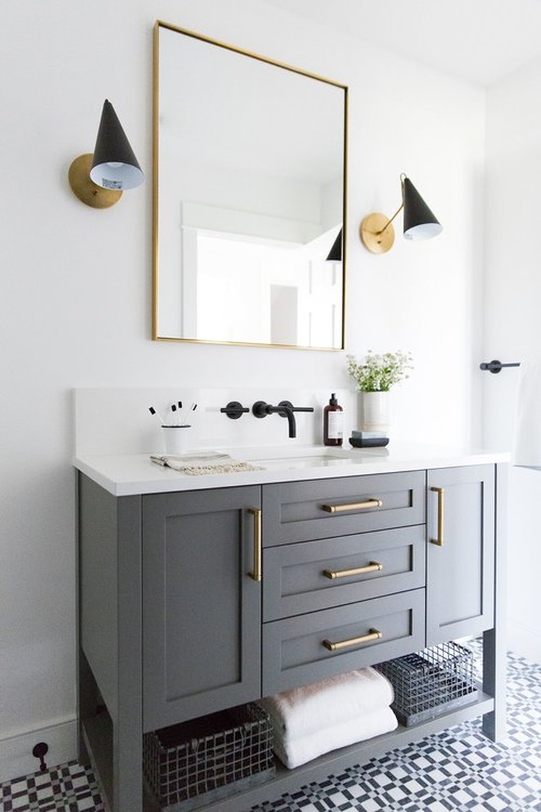 bathroom with gray vanity cabinet and patterned floor tile