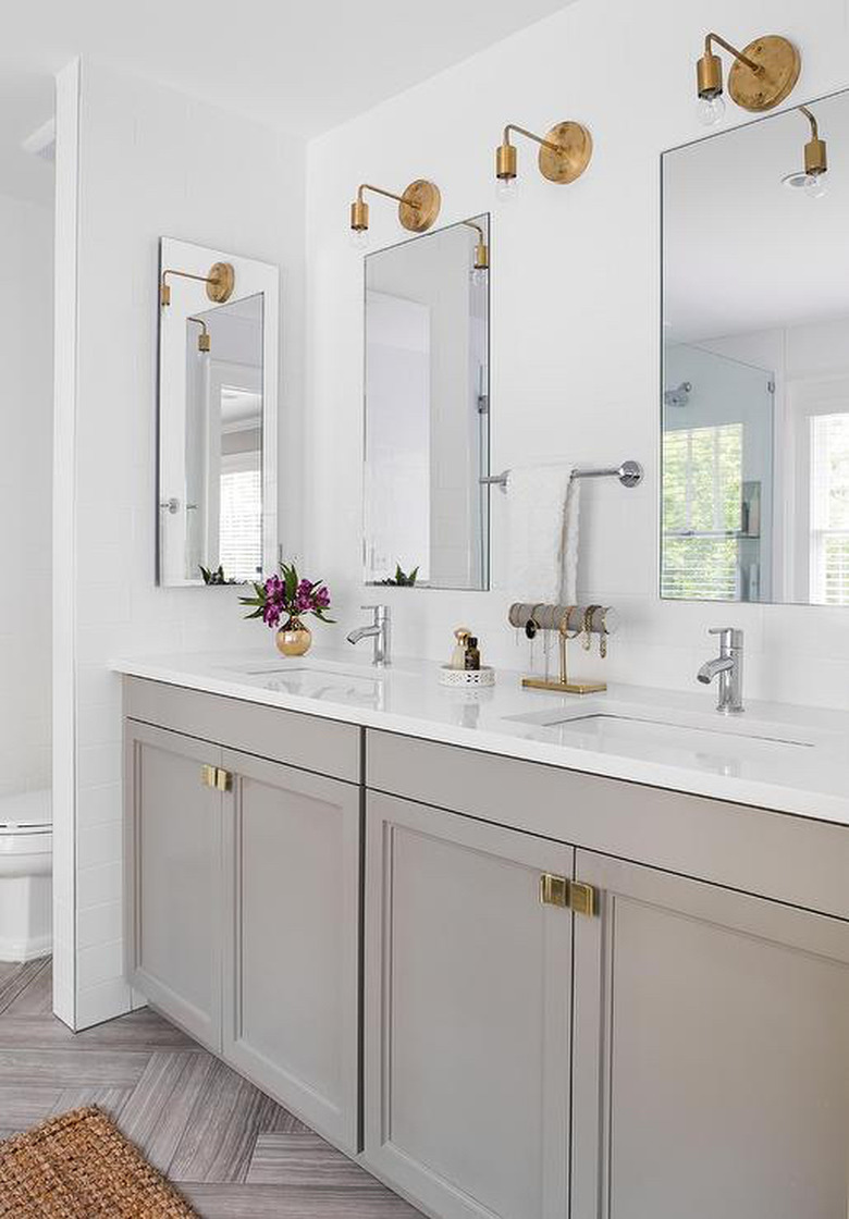 warm gray vanity cabinet with gold fixtures