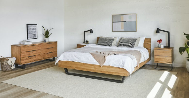 bauhaus furniture in bedroom with wood bed and wood dresser