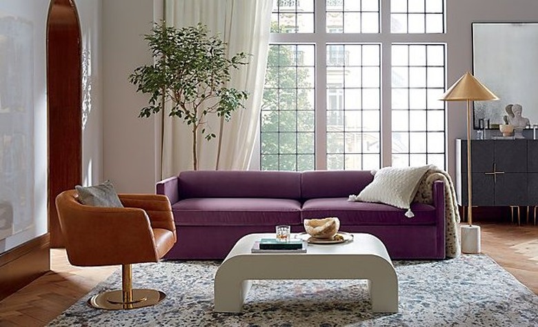 Bauhaus Furniture with brass lamp and purple couch