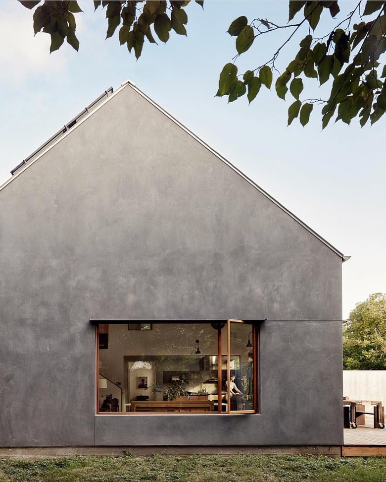 Bauhaus house with minimalist aesthetics in charcoal and an open window