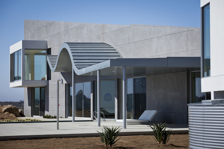 Bauhaus house with curved overhang and concrete and steel materials