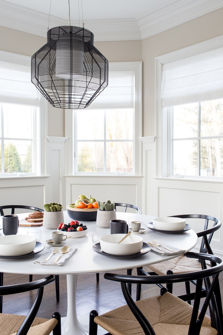 Breakfast dining nook with bright white folding bay window curtains