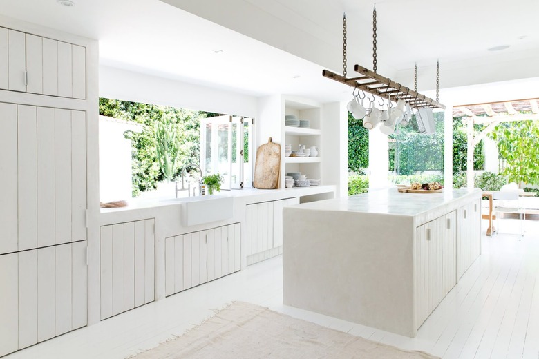 minimal white kitchen with beadboard cabinets