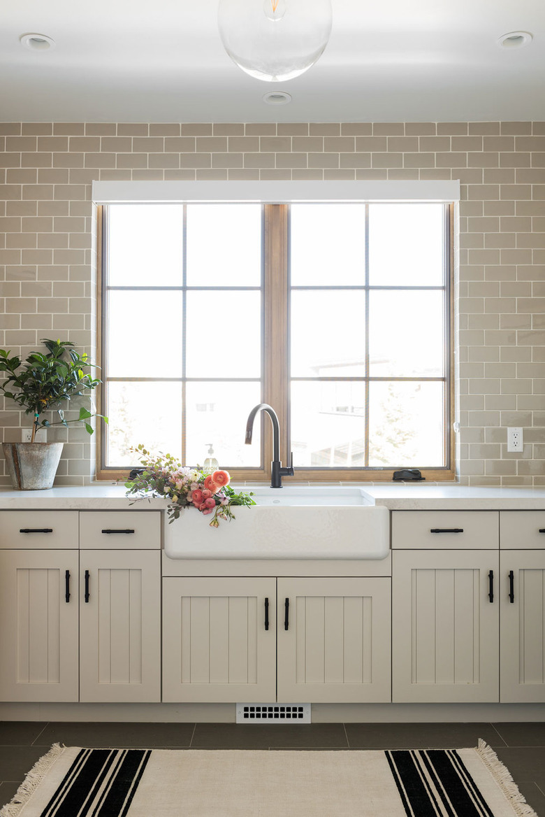 modern white kitchen with beadboard cabinet