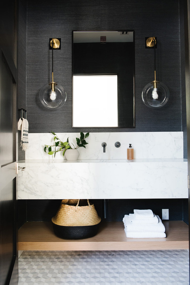 black bathroom with marble vanity and marble mosaic floor tile