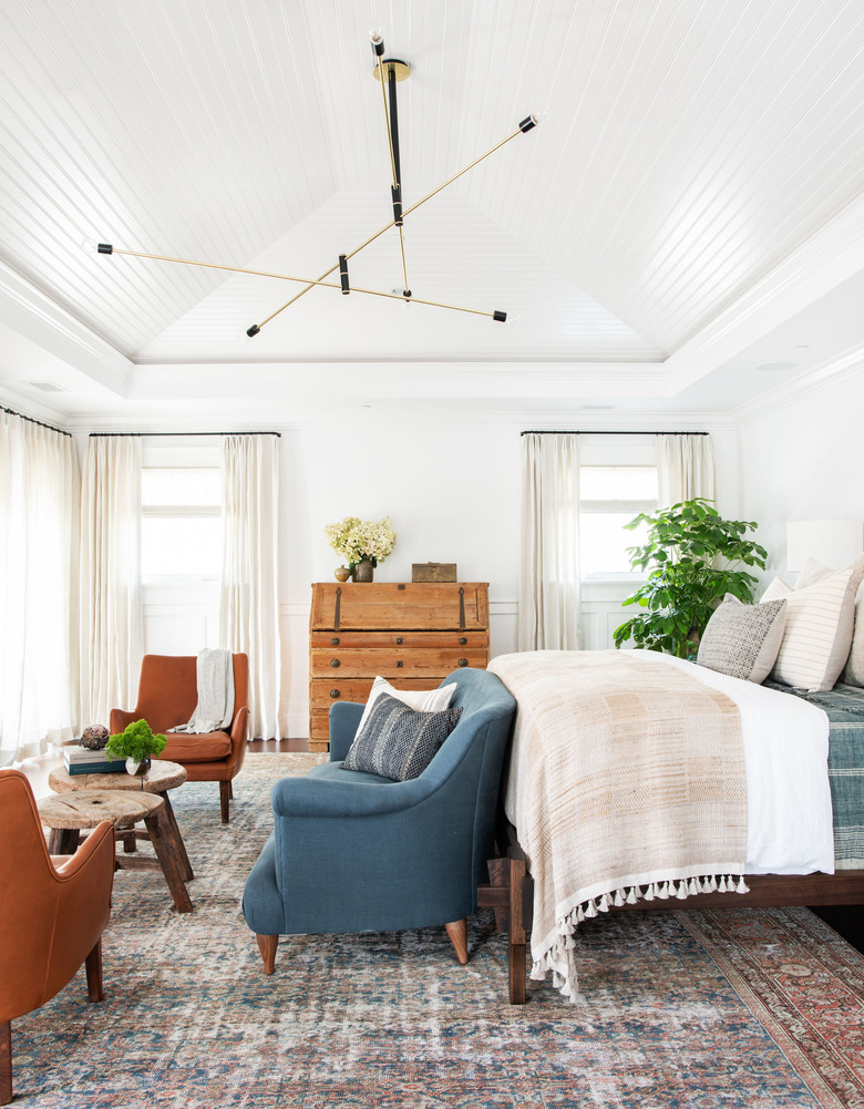 mobile bedroom chandelier hanging in the middle of the room above bed and loveseat