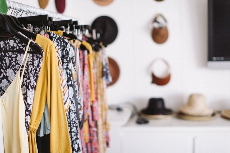 Colorful clothing hanging from a clothes rack.