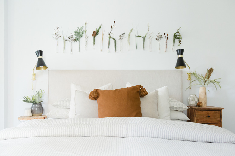 Bed with flowers and plants on wall