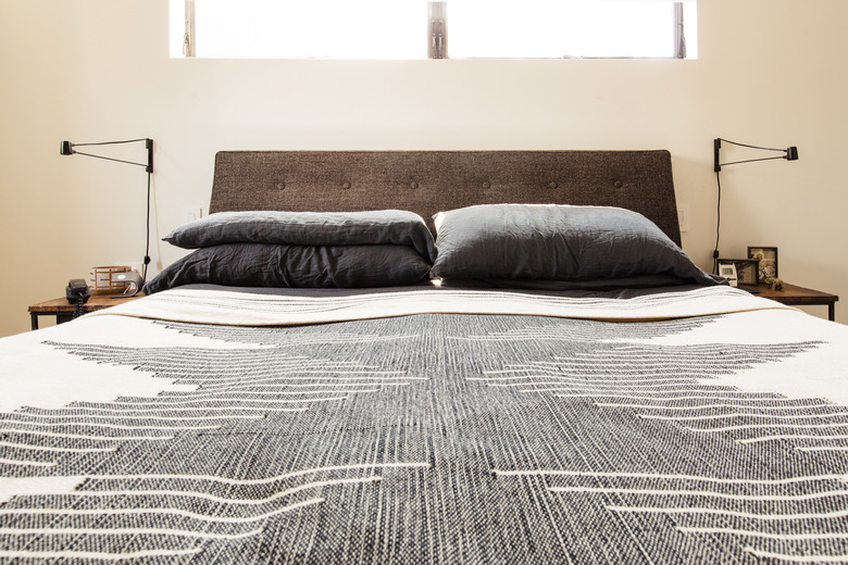 Bed with grey pillow and desert chic bedspread