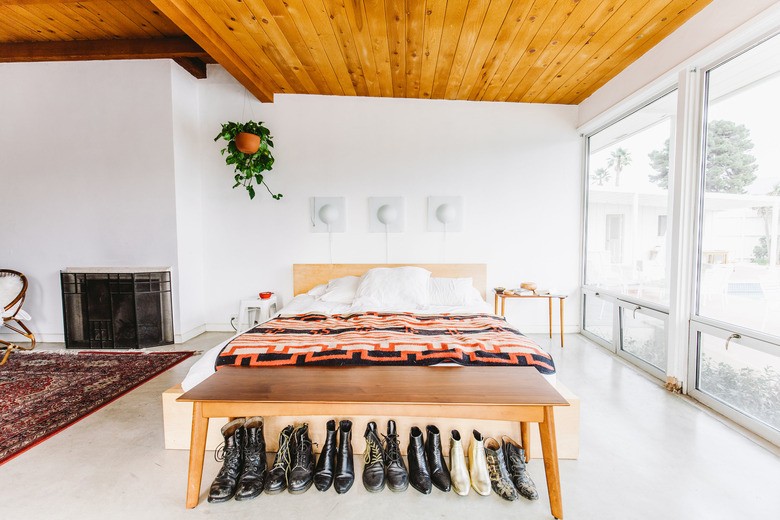 Modern bedroom with wood ceiling and fireplace