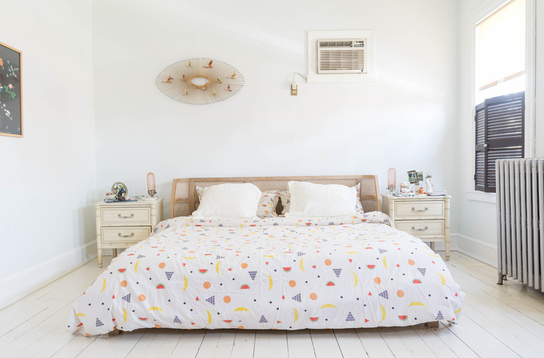 White bedroom with vintage-style nightstands