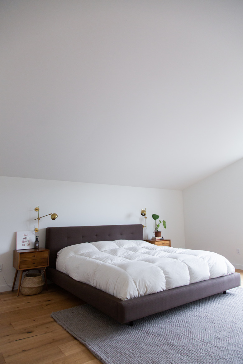 Bed in bedroom with high ceilings - The Modern Edit