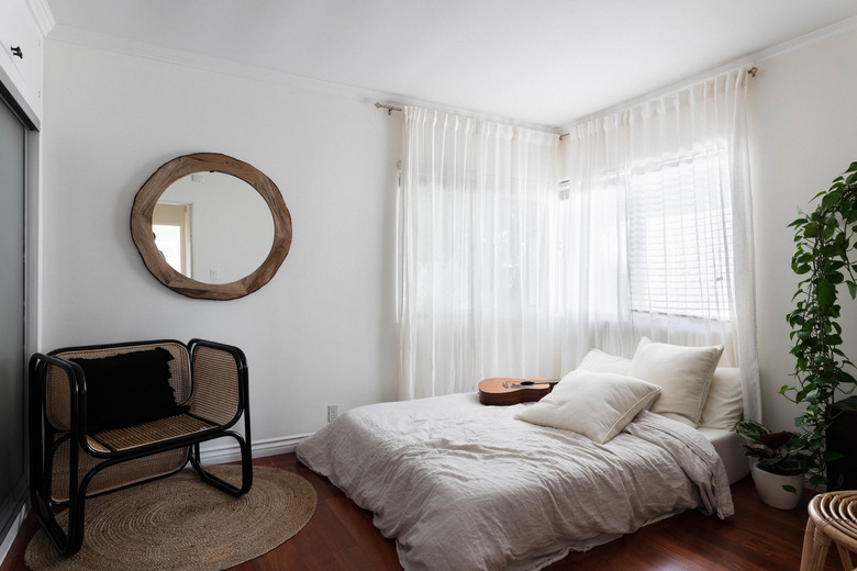 White curtains in bedroom with white bed