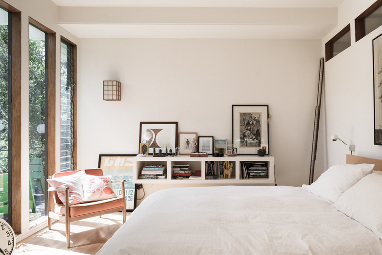 bedroom with bookcase and artwork