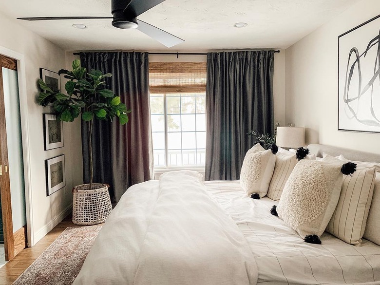 corner bedroom layout idea with fiddle leaf fig in neutral bedroom