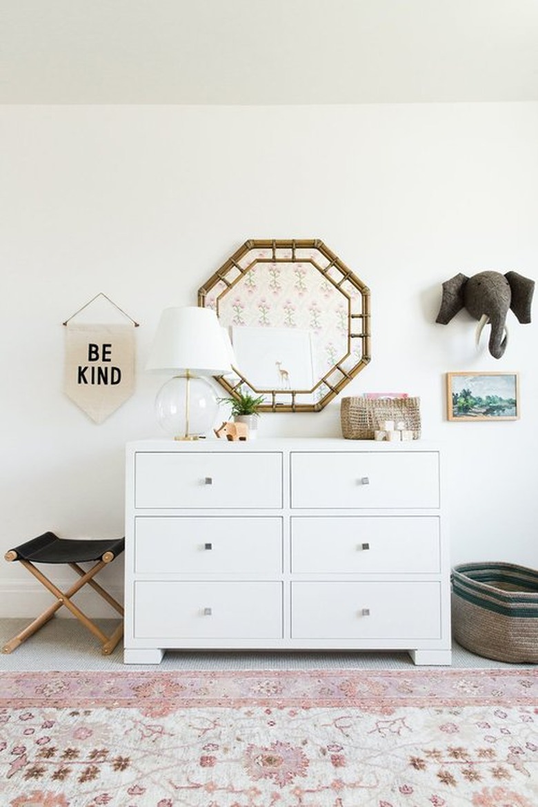 girls bedroom idea with pink area rug and white six drawer dresser