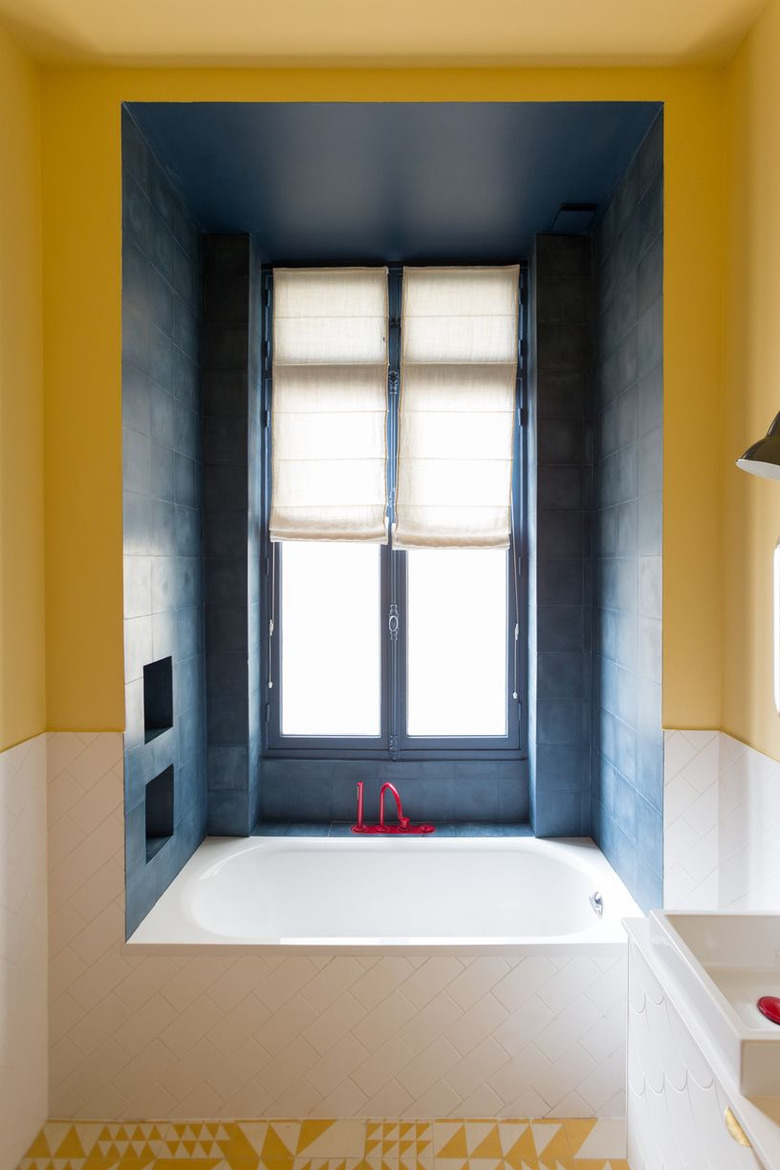 yellow bathroom with built-in bathtub