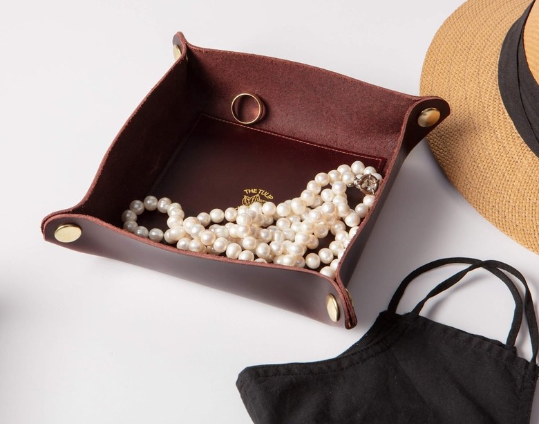 deep red leather tray filled with jewelry