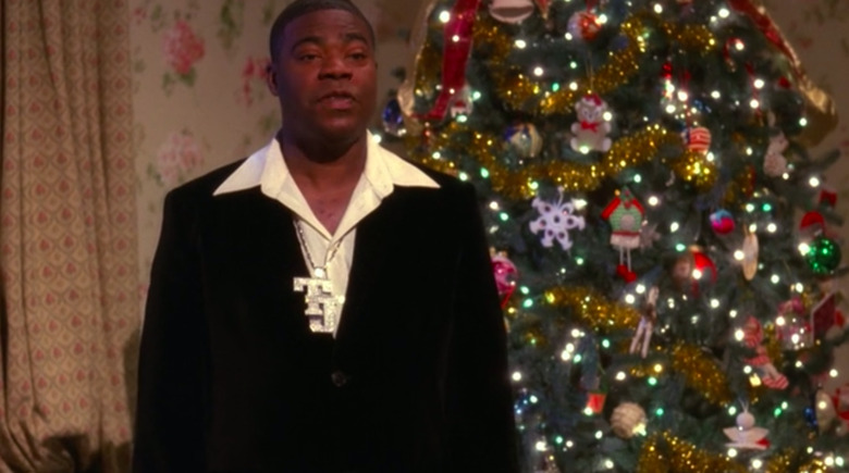 man standing in front of Christmas tree