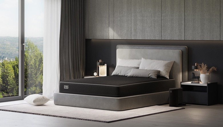 Black mattress on gray bed frame