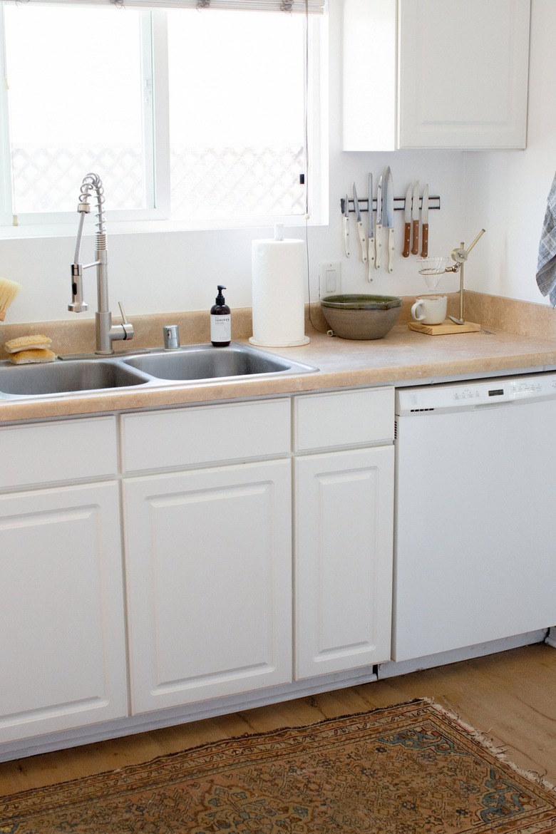 white kitchen with laminate countertops and stainless steel sink