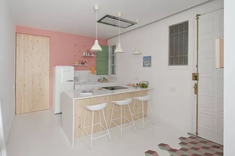 modern kitchen with bubblegum pink walls and smeg fridge