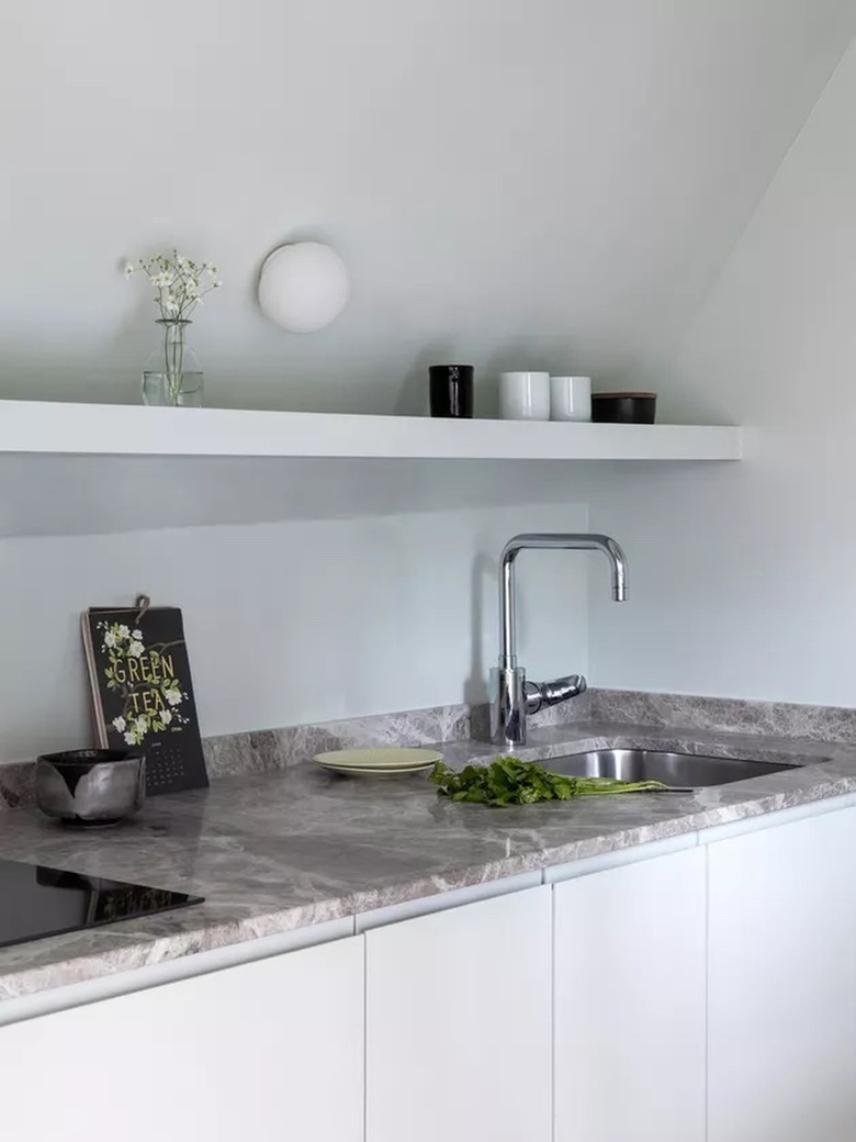 light blue kitchenette with gray marble counters